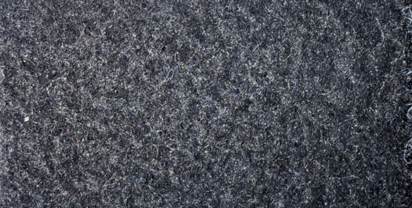 Detalle de textura de moqueta Pigalldis tipo rizo con fibras compactas en tono gris oscuro