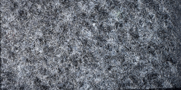 Detalle de textura de moqueta Pigalldis tipo rizo con fibras compactas en tono gris oscuro