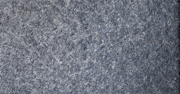 Detalle de textura de moqueta Pigalldis tipo rizo con fibras compactas en tono gris oscuro