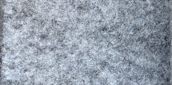 Detalle de textura de moqueta Pigalldis tipo rizo con fibras compactas en tono gris oscuro