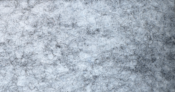 Detalle de textura de moqueta Pigalldis tipo rizo con fibras compactas en tono gris oscuro